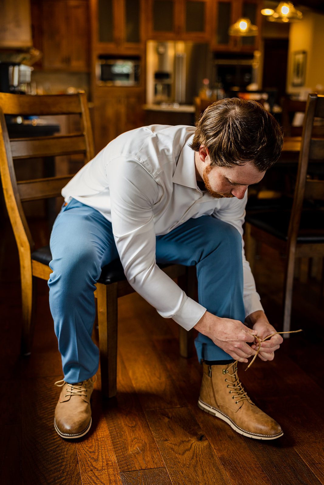 The groom tying his shoes before his Hidden Valley Elopement in Colorado. 
