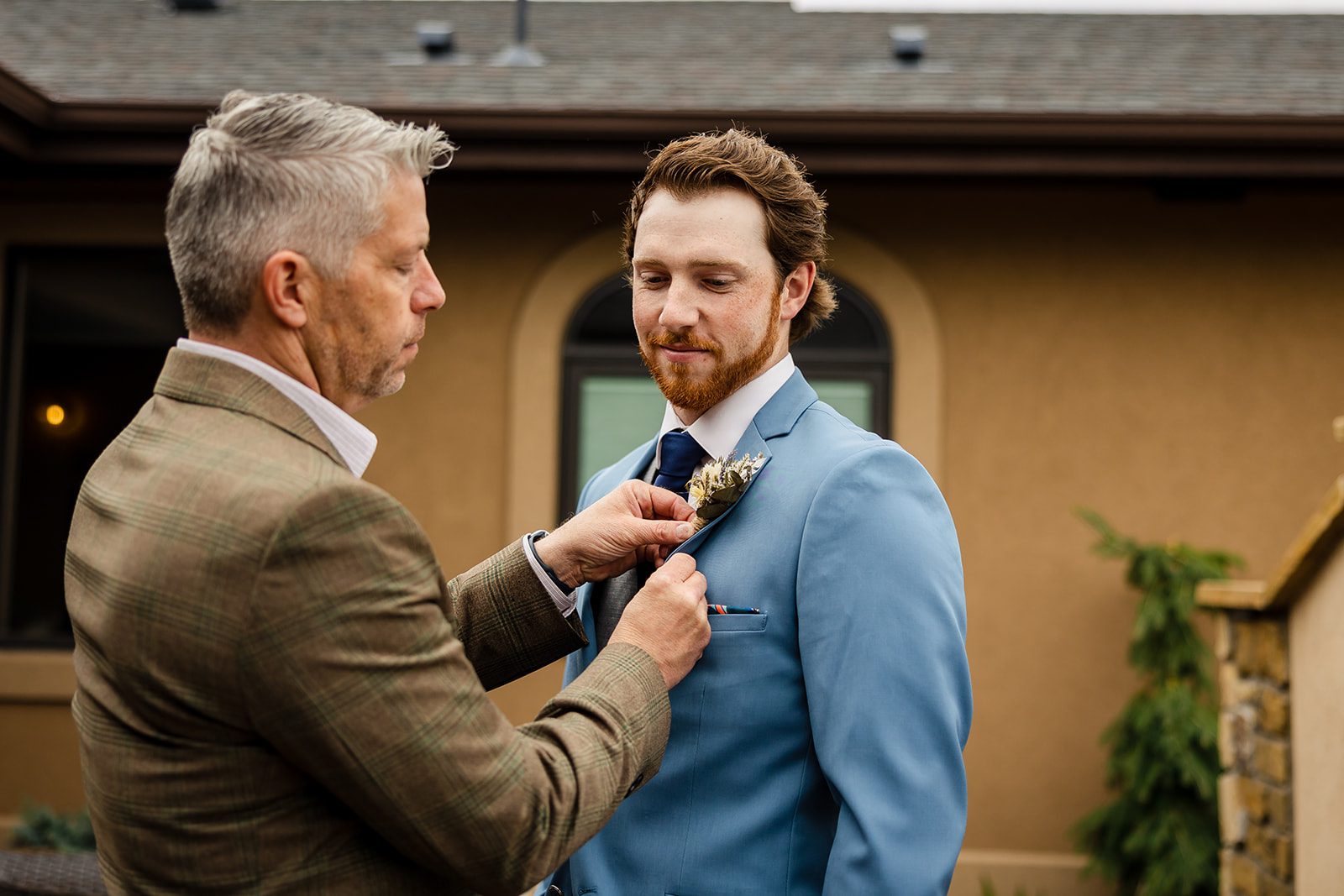 Groom getting his boutonniere pinned on before his Hidden Valley Elopement