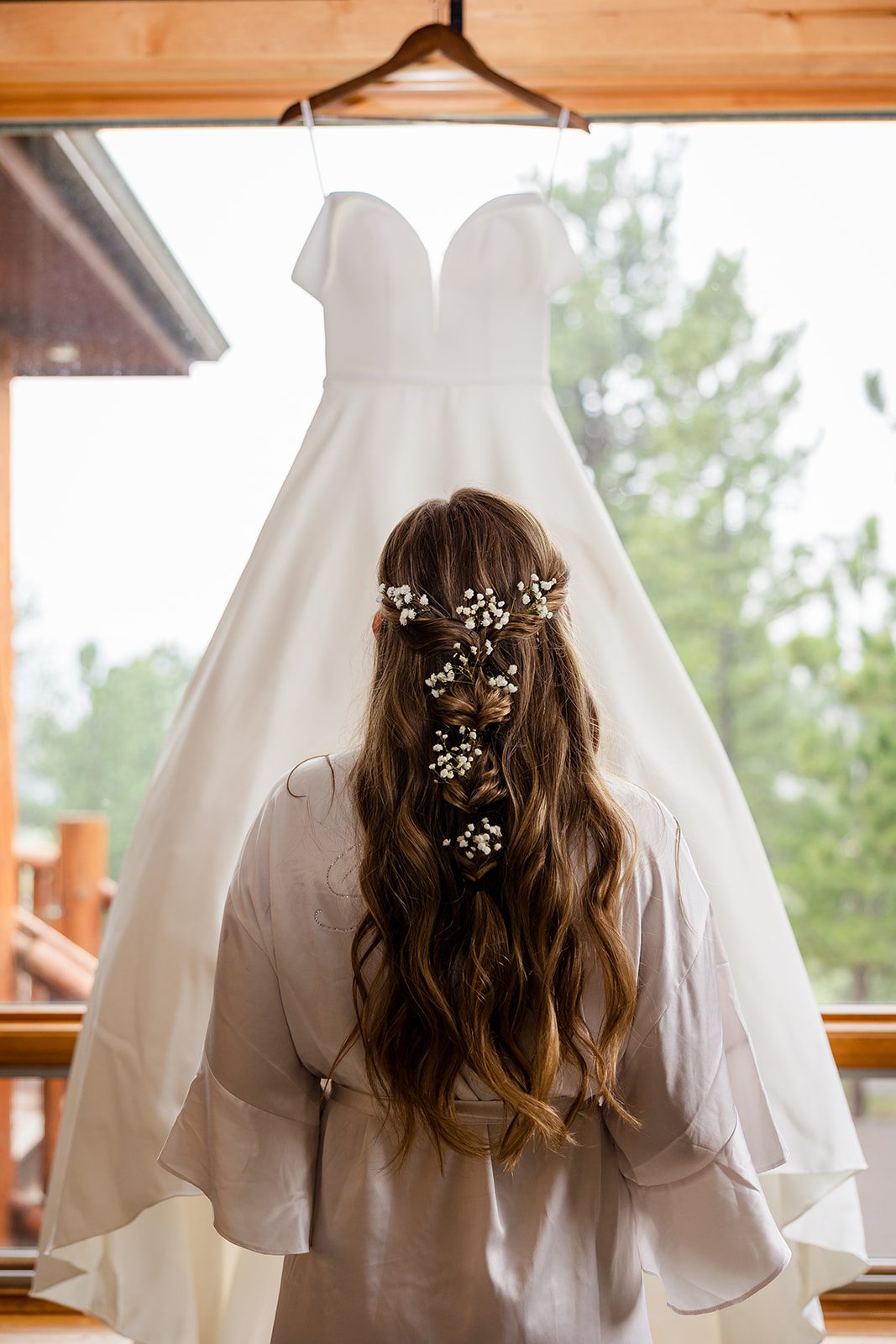 The bride looking at her wedding dress before her Hidden Valley Elopement ceremony. 