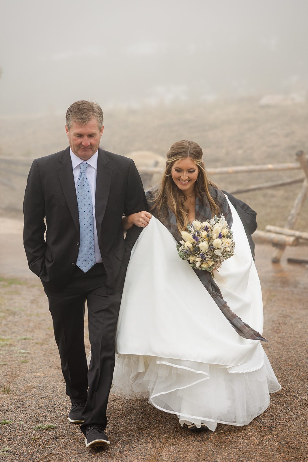 Father and bride walk down the aisle at Hidden Valley Elopement ceremony in Rocky Mountain National Park