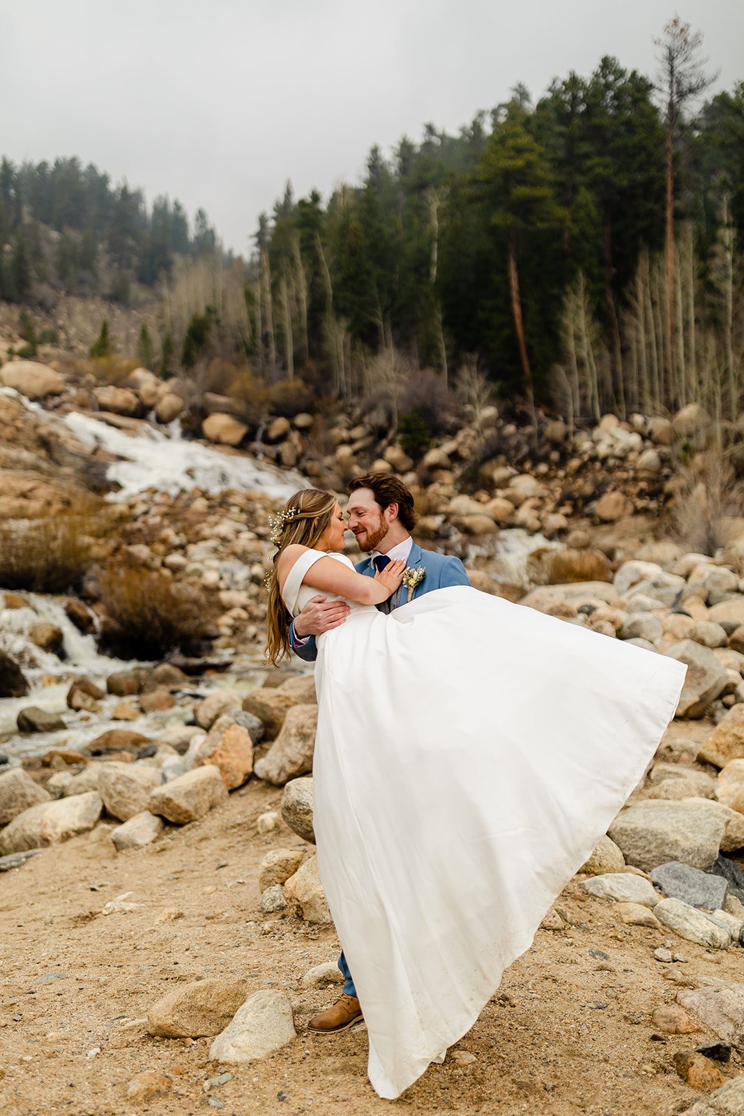 Groom picking up bride, Colorado Elopement photos at at Alluvial Fan Bridge in Rocky Mountain National Park