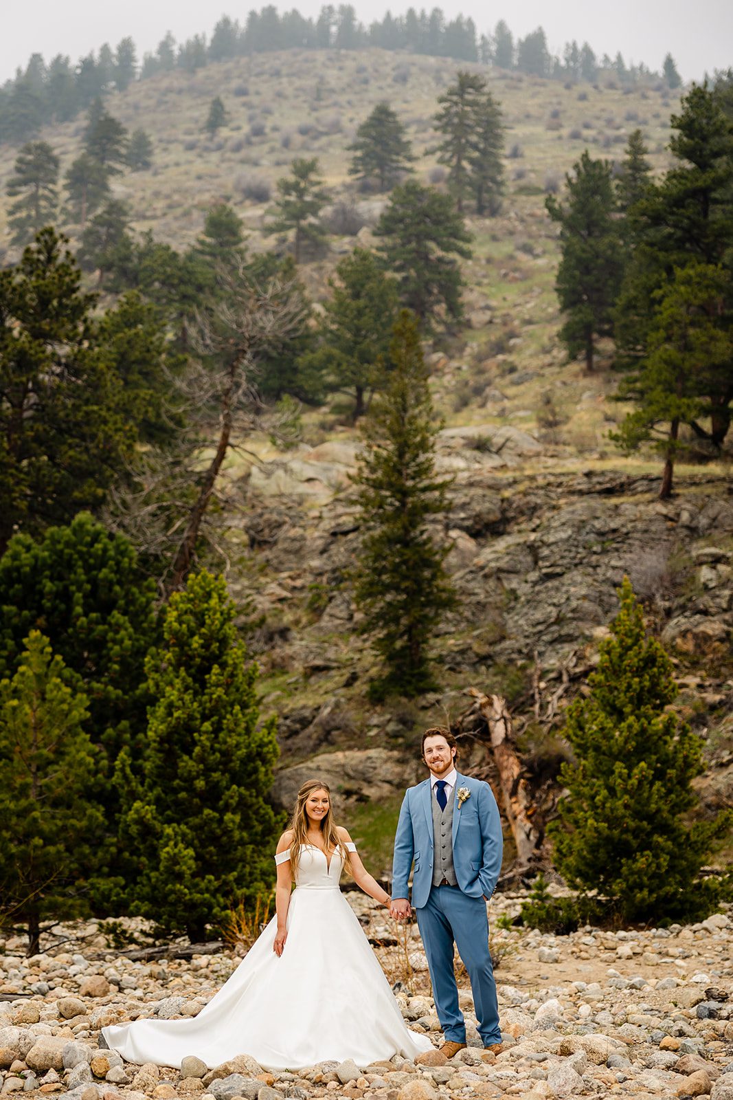 Bride and Groom holding hands, Colorado Elopement photos at at Alluvial Fan Bridge in Rocky Mountain National Park