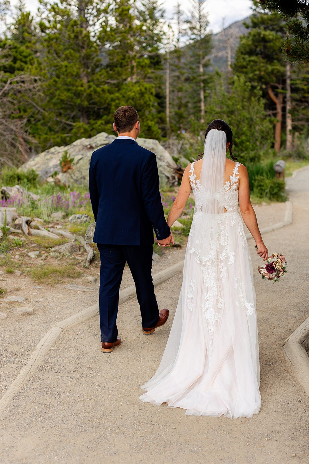 Bride and groom walking to their Sprague Lake elopement ceremony.