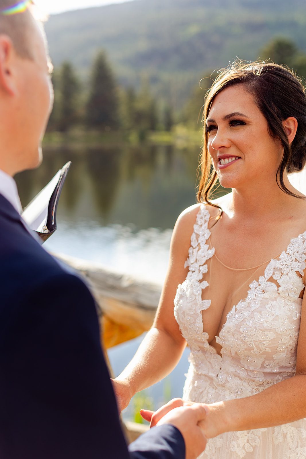 Bride smiling at groom during summer elopement at Sprague Lake