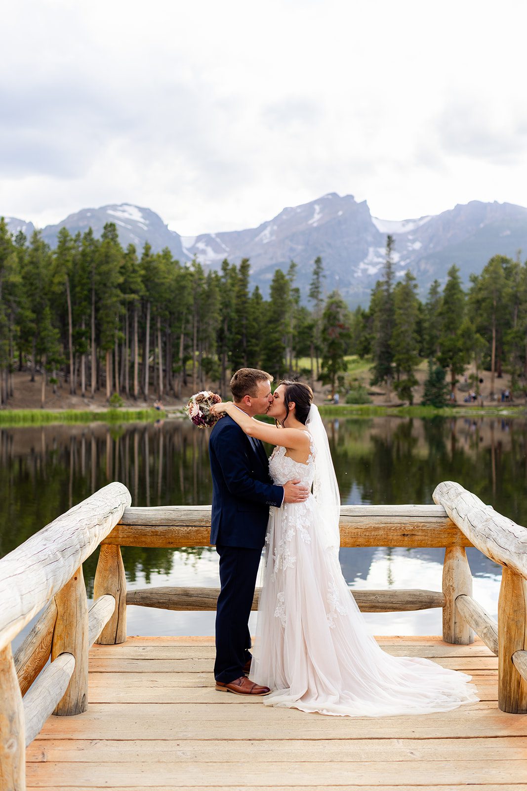 bride and groom kissing after their summer elopement at sprague lake
