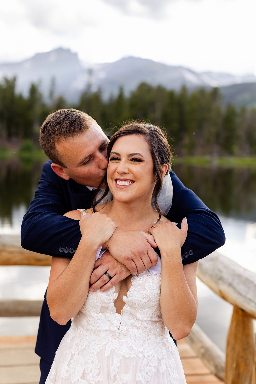 Groom kissing his beautiful bride after their summer elopement at Sprague Lake.