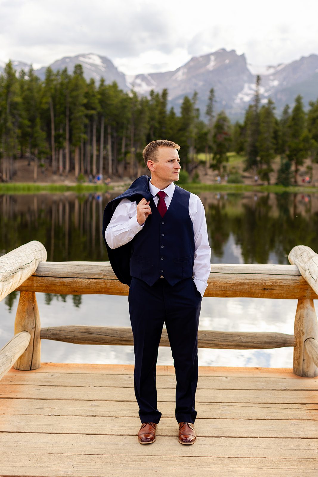 Groom in blue suit at Sprague Lake with his jacket off