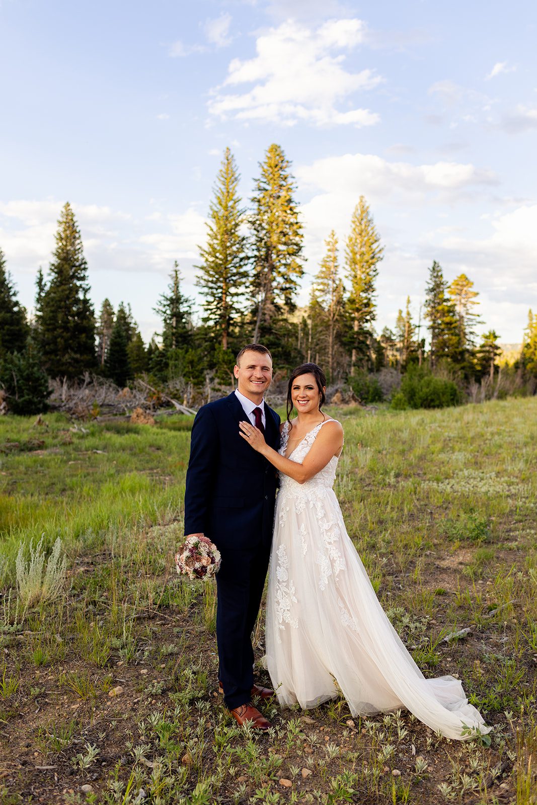 Bride and groom smiling at camera after their sprague lake elopement ceremony