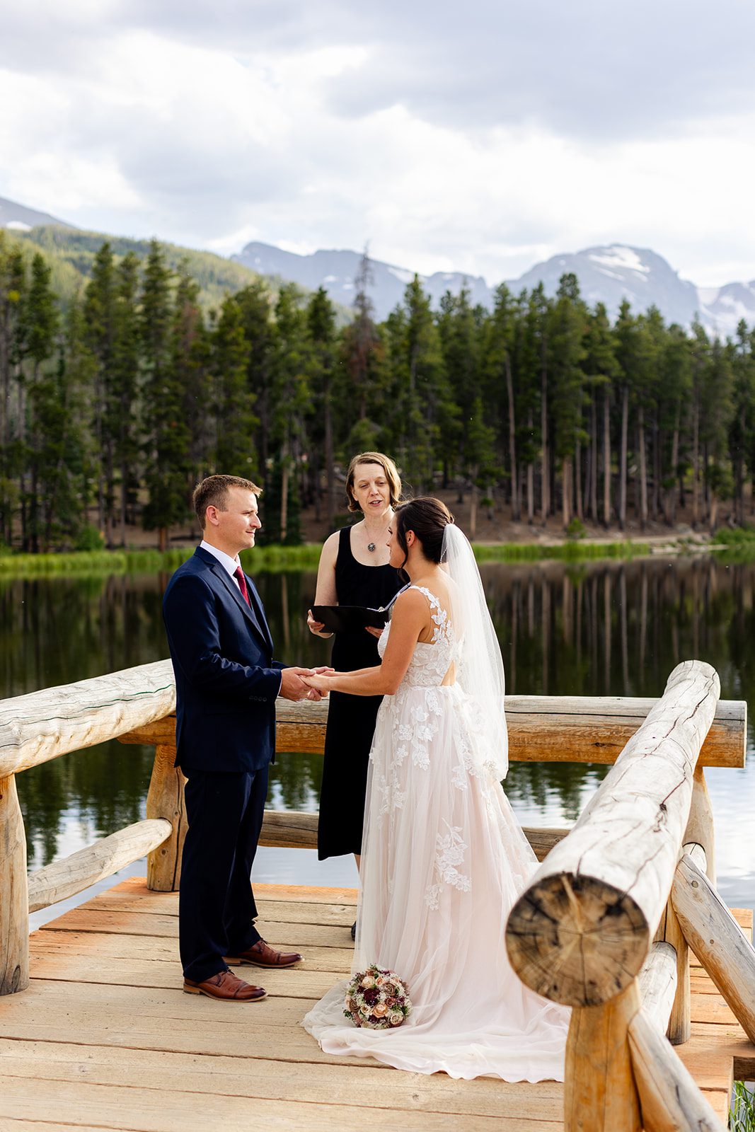 bride and groom hold hands during their summer elopement at Sprague Lake