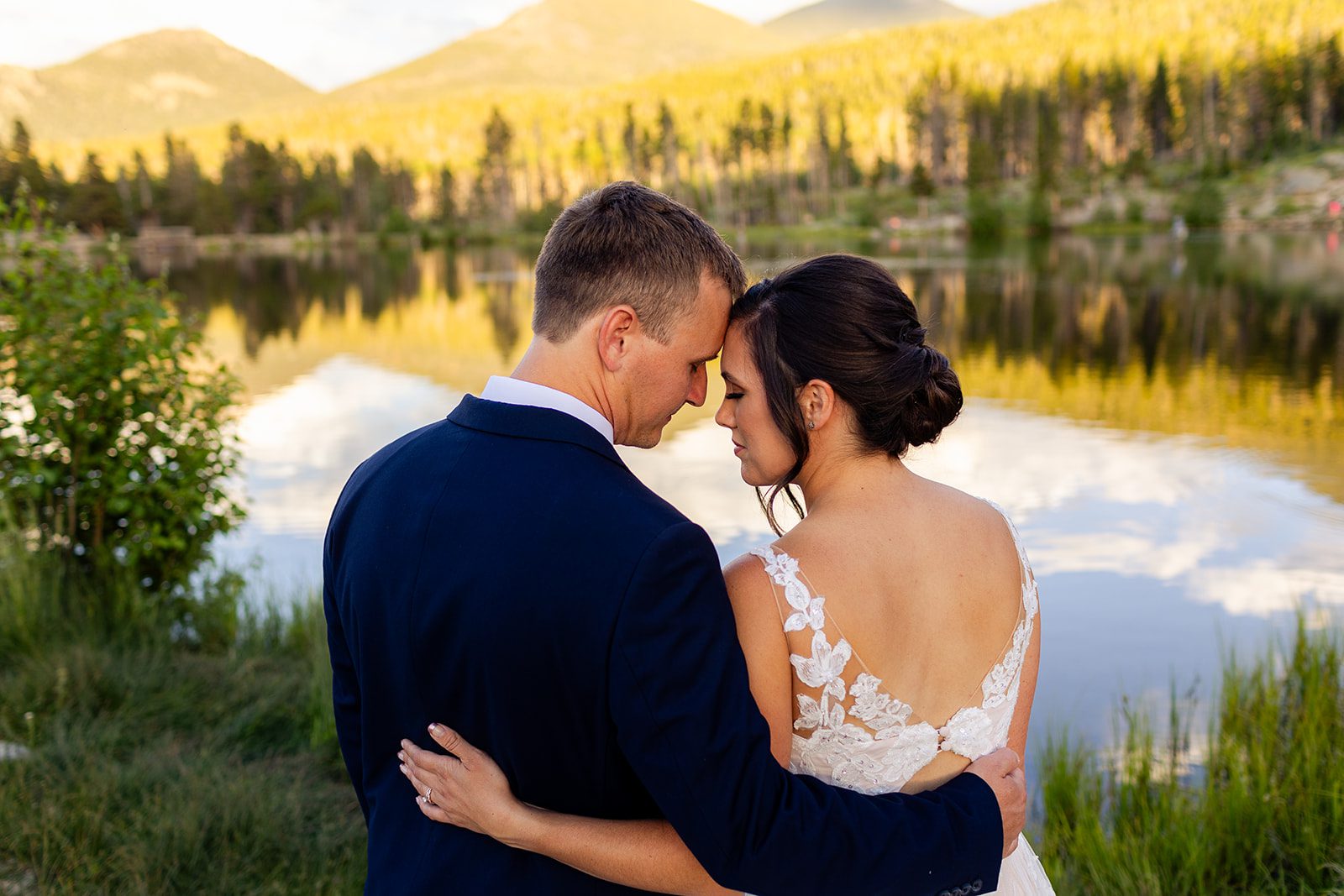 bride and groom nose-to-nose in front of Sprague Lake after Summer elopement