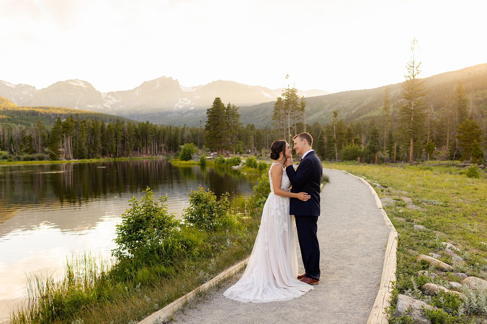 Bride and groom during sunset at Sprague Lake for their summer elopement
