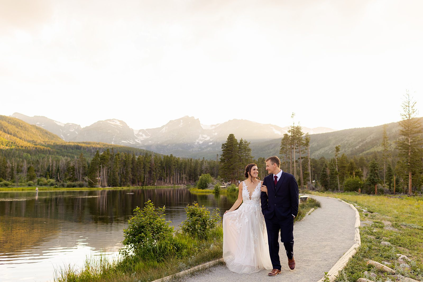 Bride and Groom walk around Sprague Lake after their elopement ceremony