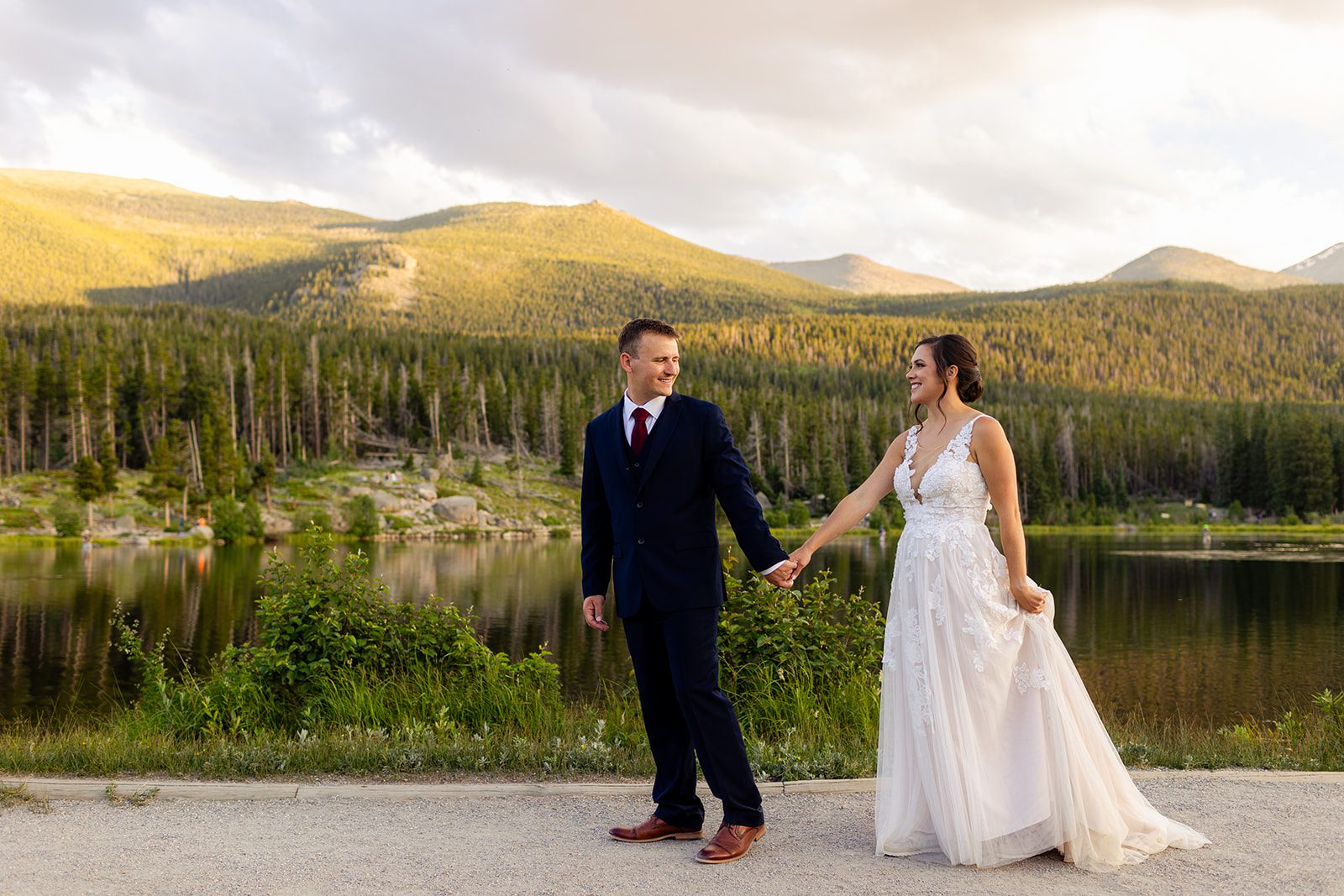 bride and groom holding hands in Rocky Mountain National Park for their elopement
