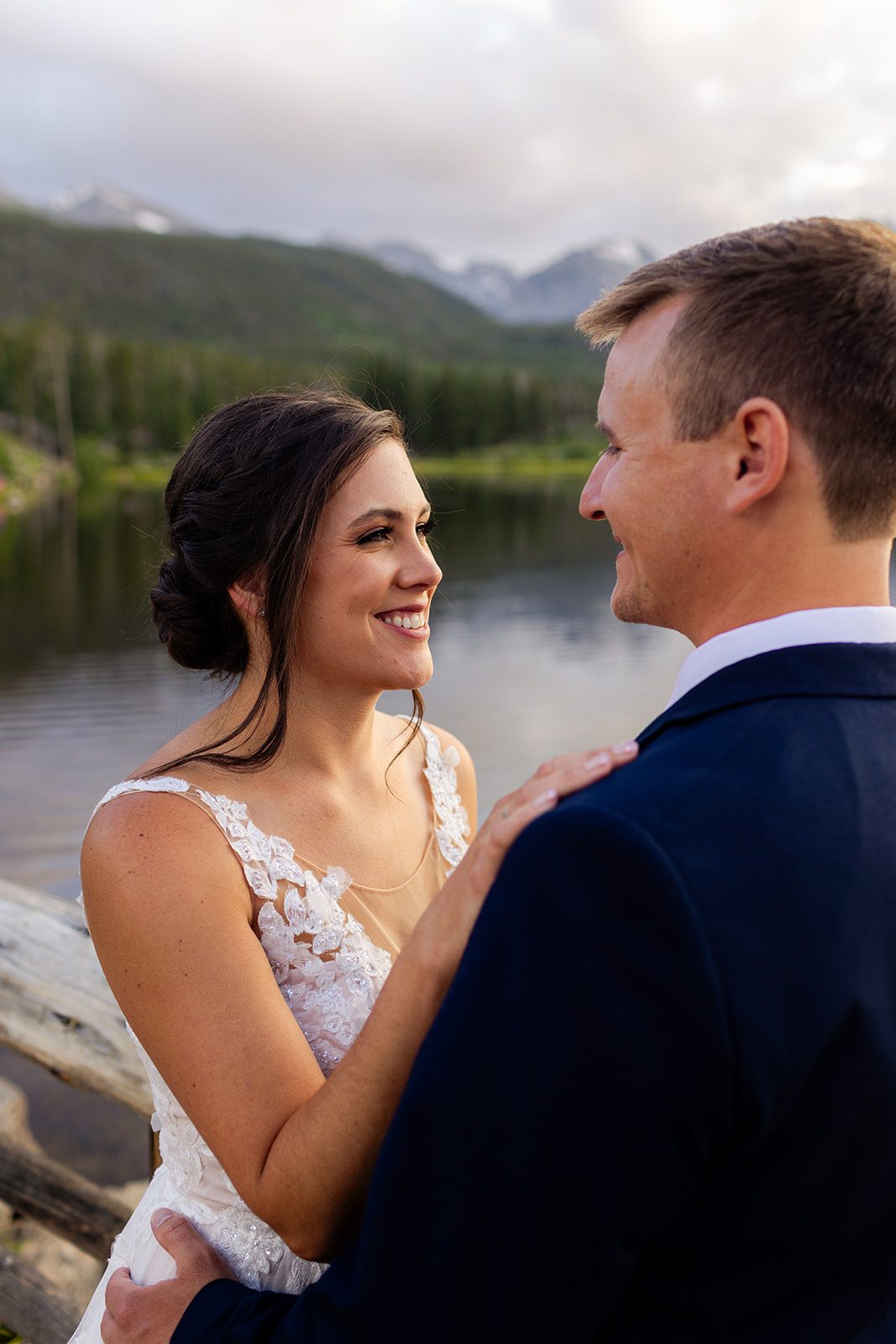 upclose photo of bride and groom smiling at each other at Sprague Lake after their elopement ceremony