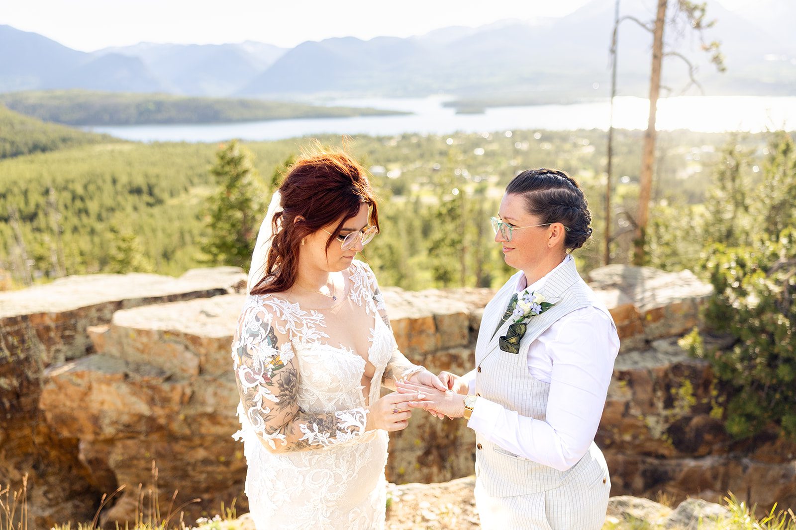 Bride puts ring on her partners hand during  Summit County Elopement ceremony. 