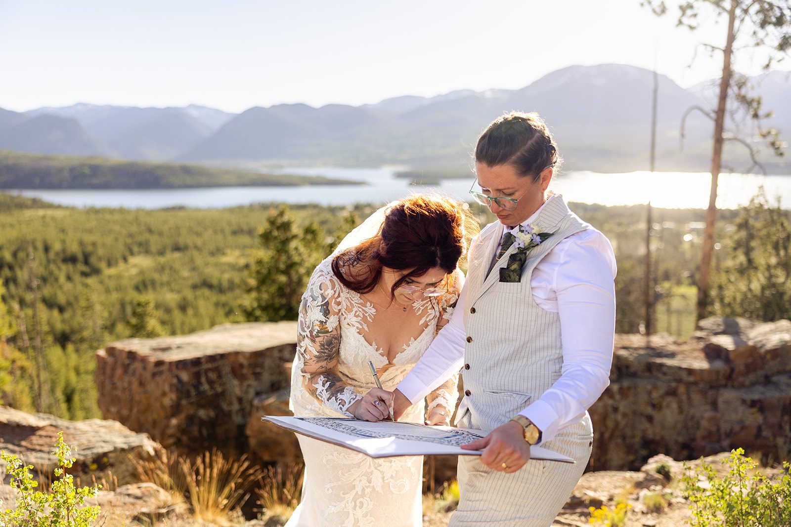 couple during  Summit County Elopement signing the Ketubah 