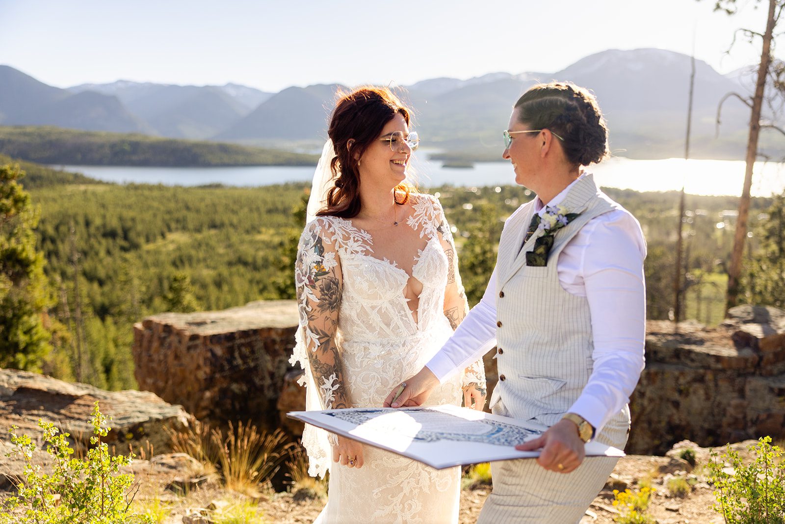 couple smiling at each other after signing the Ketubah, Jewish tradition during Summit County Elopement