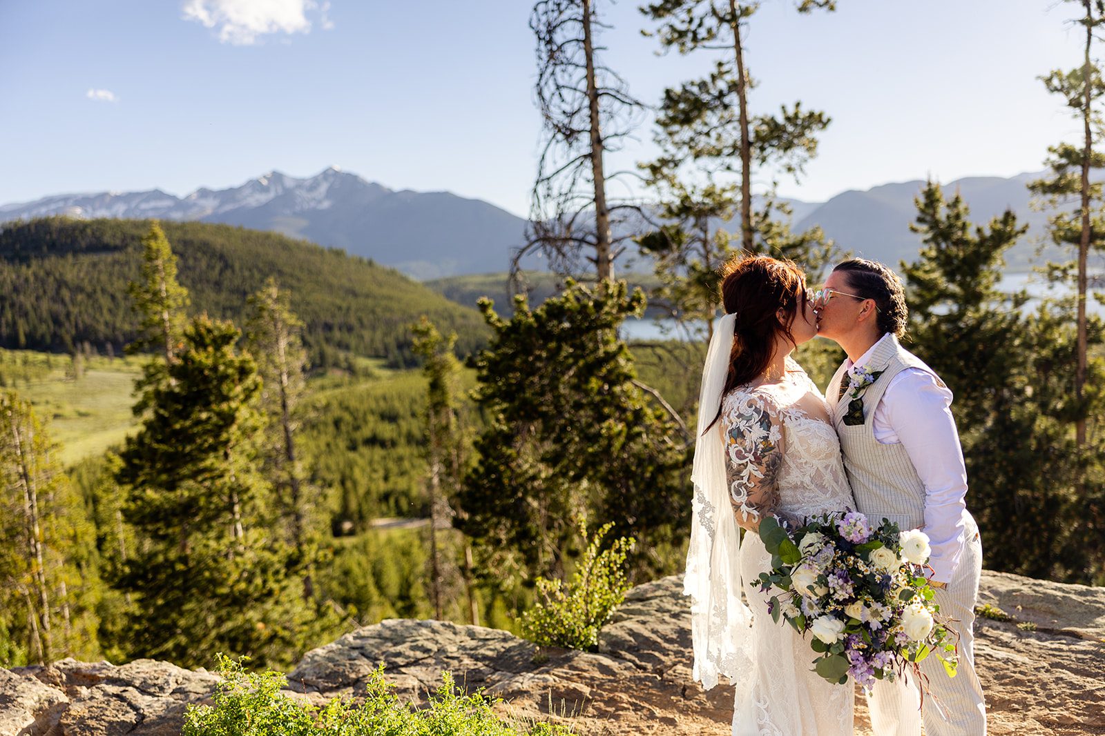 Two brides kissing at sunset after their Summit County Elopement