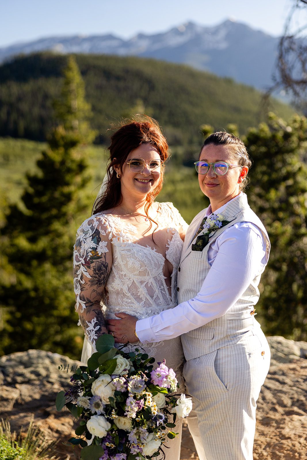 Bride and partner smile at camera after their Summit County Elopement ceremony. 