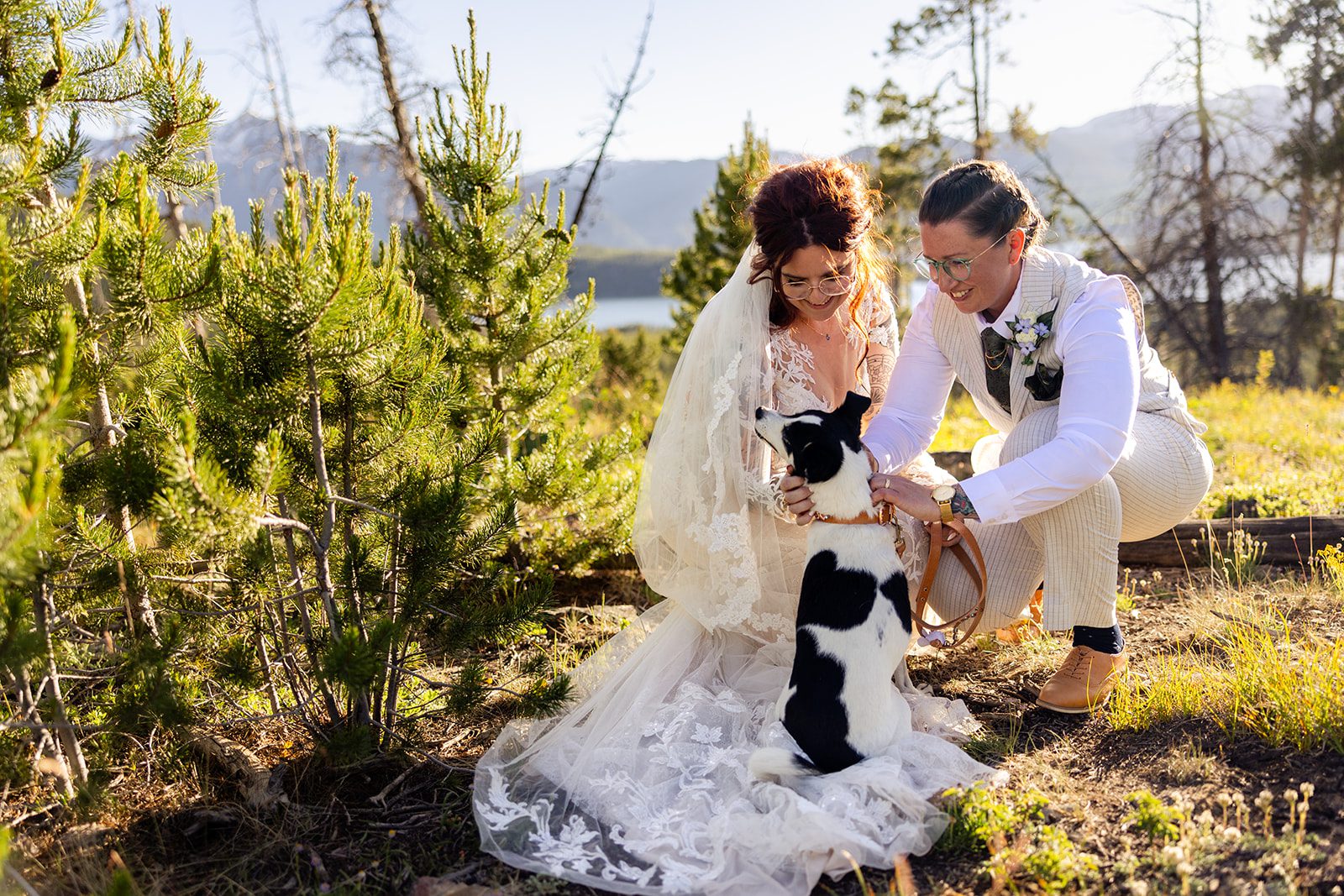 LBGTQ couple pet dog during Summit County Elopement at sunset. 
