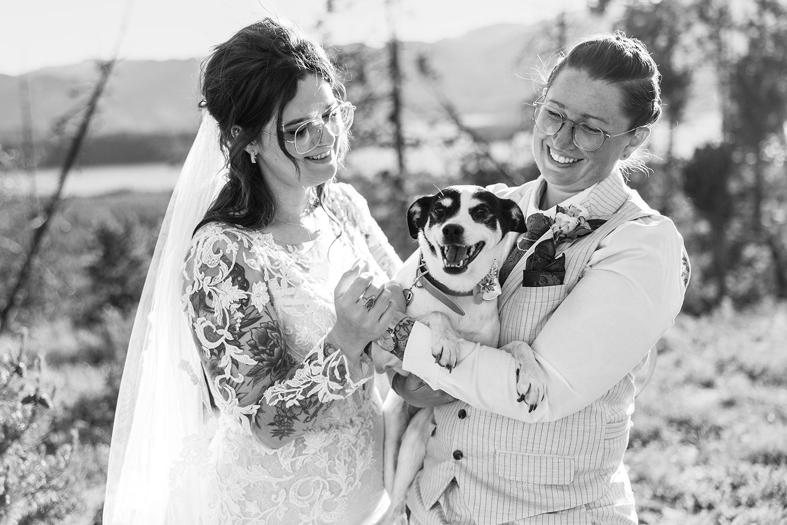 Black and white photo of two brides and their dog at Summit County Elopement.
