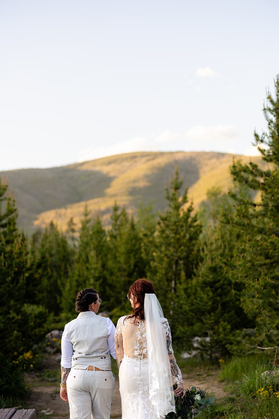 sunset photo of two brides walking together at Summit County Elopement