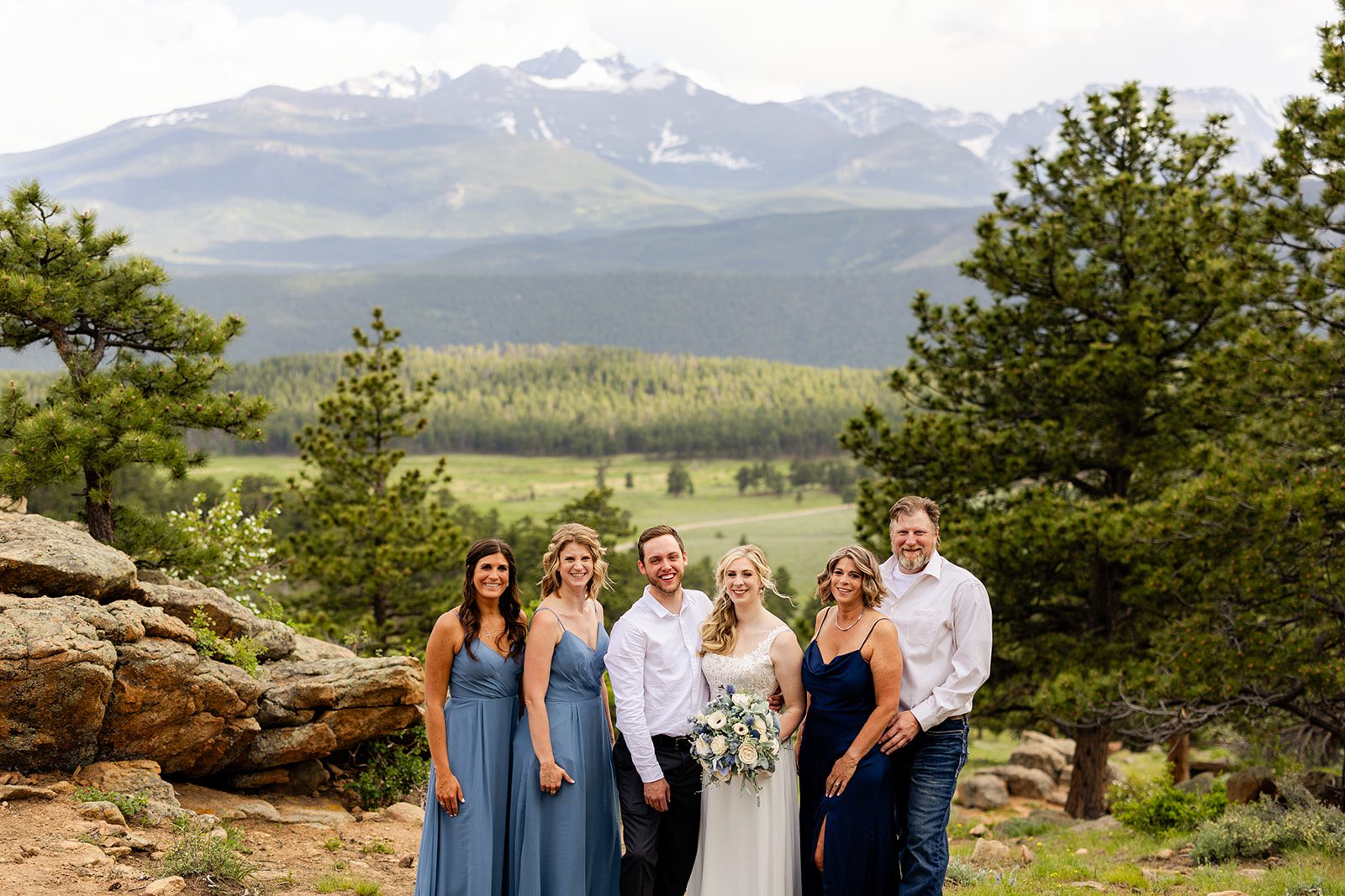 family photo with bride and groom in rocky mountain national park, after summer elopement.