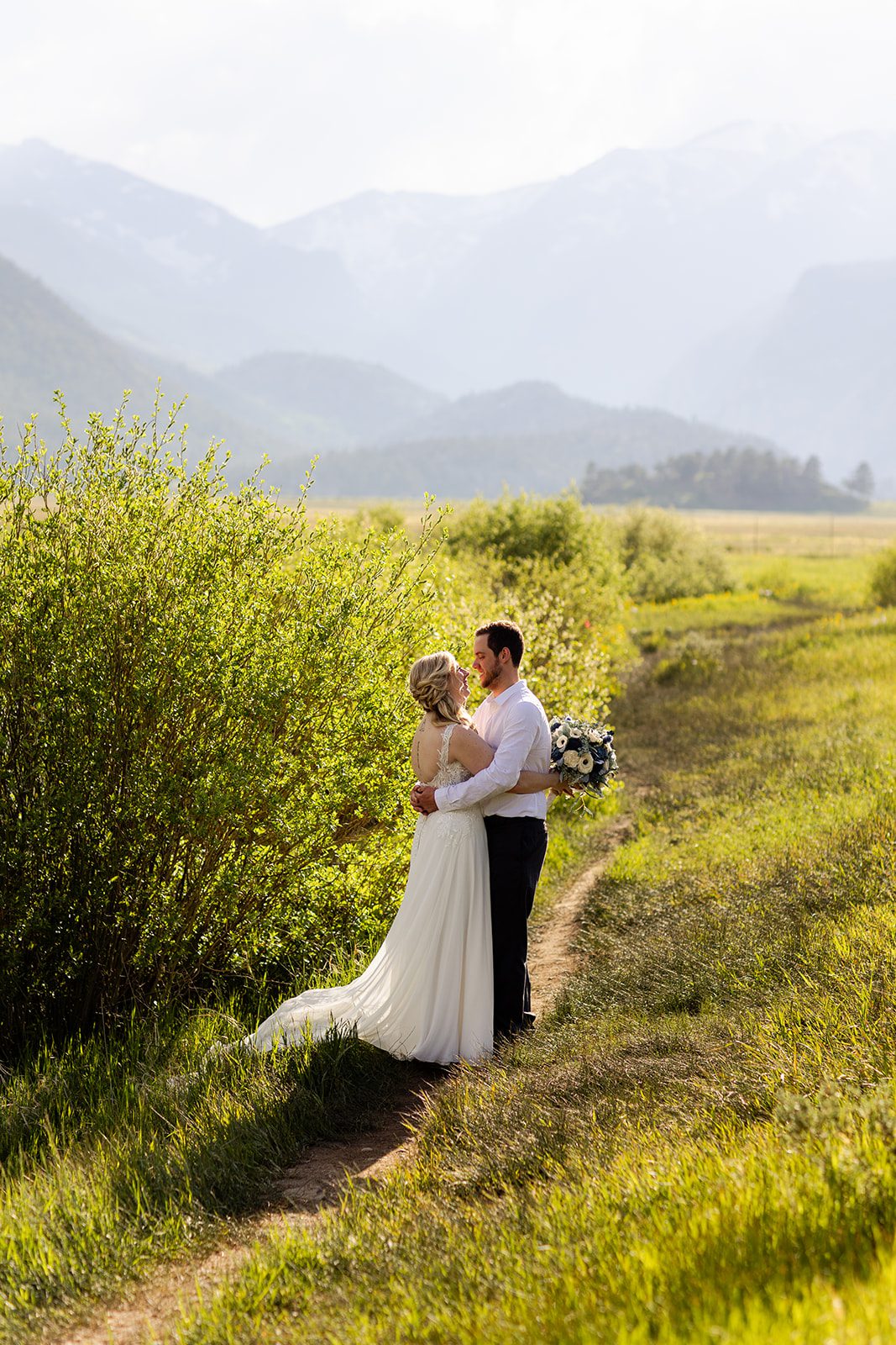 bride and groom kissing in rocky mountain national park after their Summer Elopement at 3M Curve.