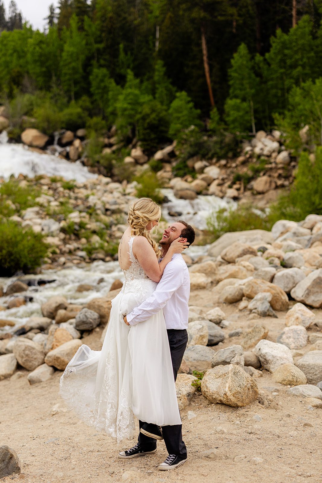 bride and groom after their summer elopement at 3m curve, taking bridal portraits at alluvial Fan Bridge & Waterfall