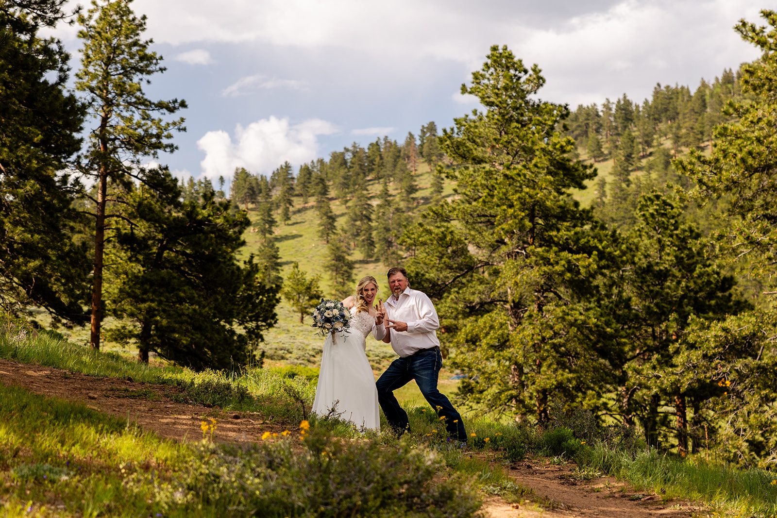 Bride and her dad silly pose at Rocky Mountain National park.