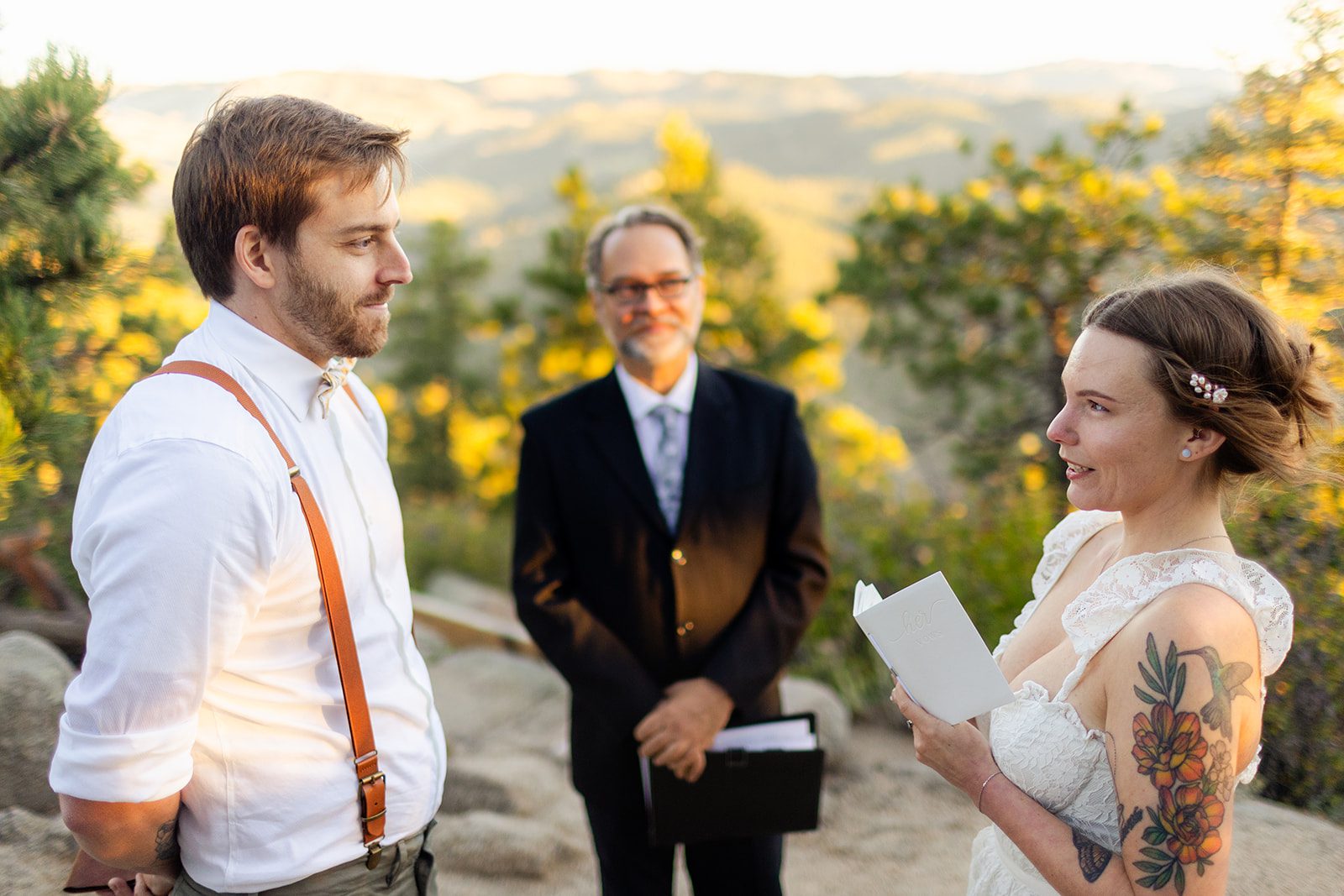 bride reads her vows to her groom at sunrise at Artist Point in colorado