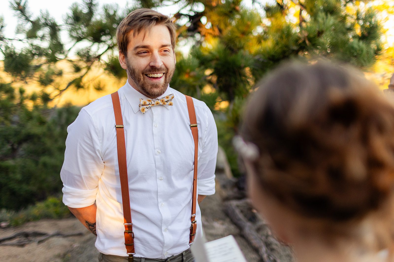 groom smiles during elopement ceremony at sunrise