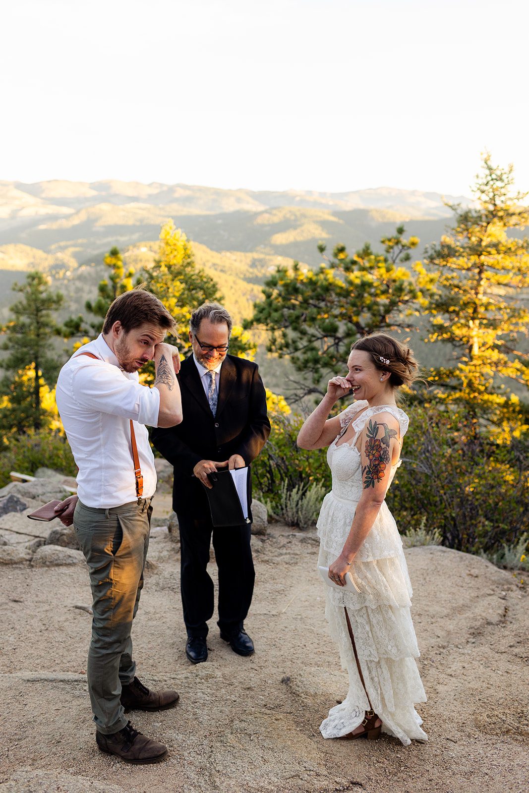 bride and groom wipe tears from their eyes after reading vows during Sunrise Elopement at Artist Point