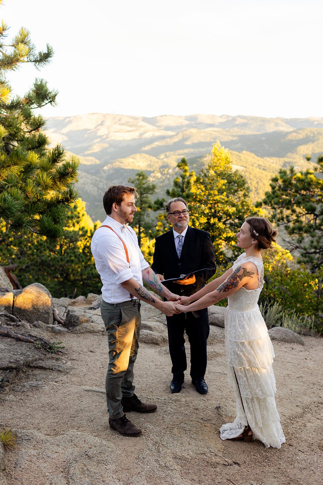 bride and groom holding hands during sunrise elopement ceremony at Artist Point in Colorado