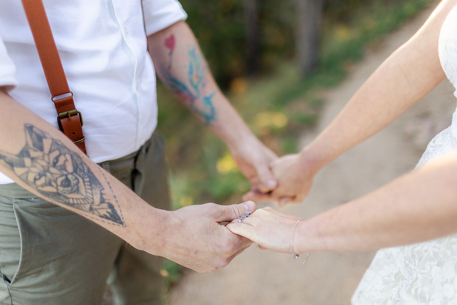 upclose photo of bride and groom holding hands. 