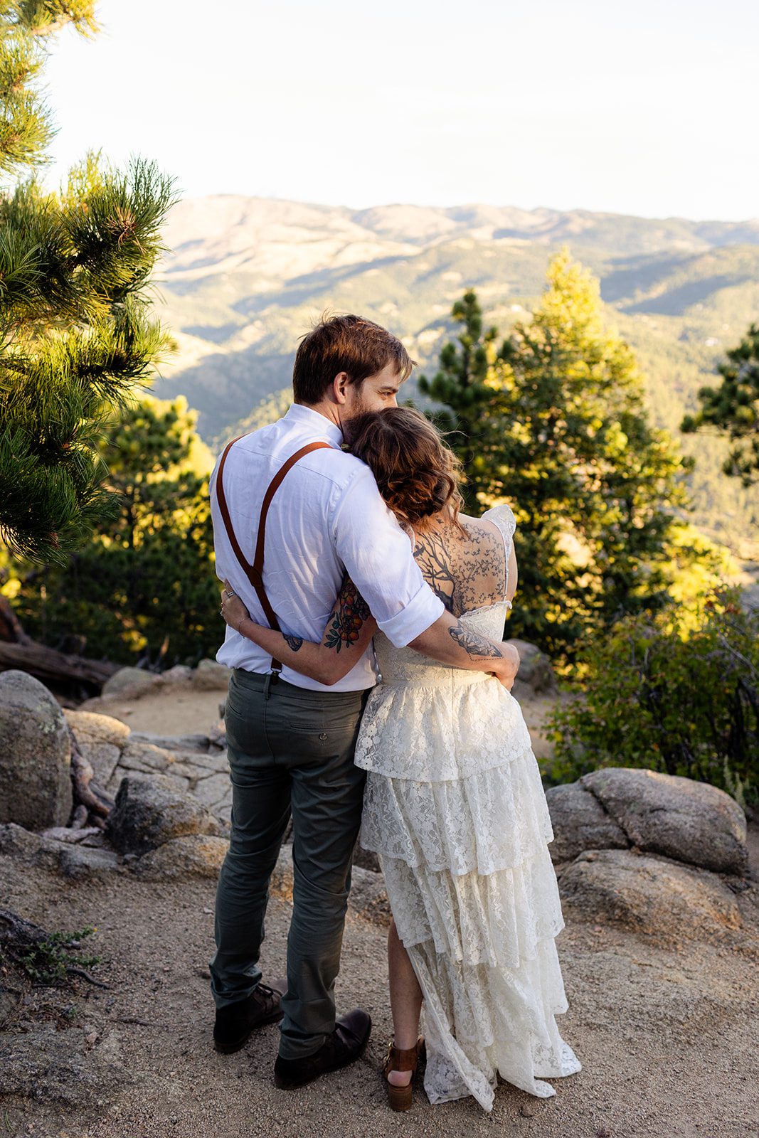 groom holds his bride after a sunrise elopement at Artist Point.