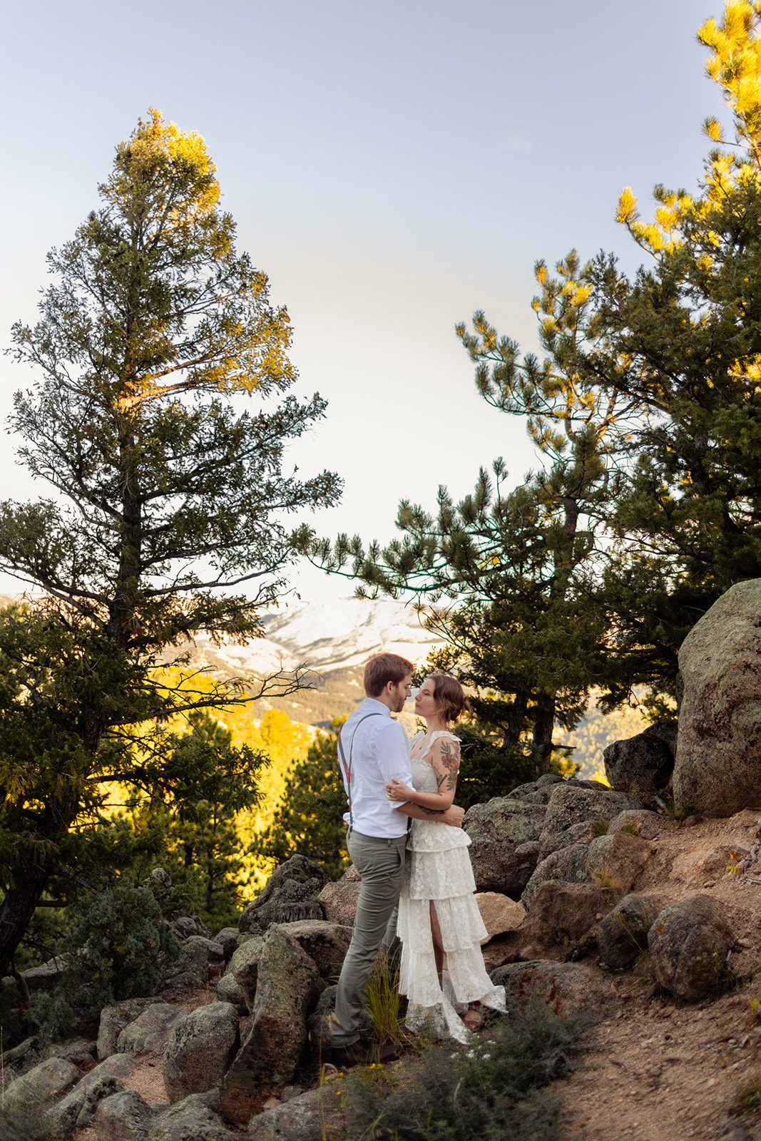bride and groom between the trees for elopement at sunrise at artist point