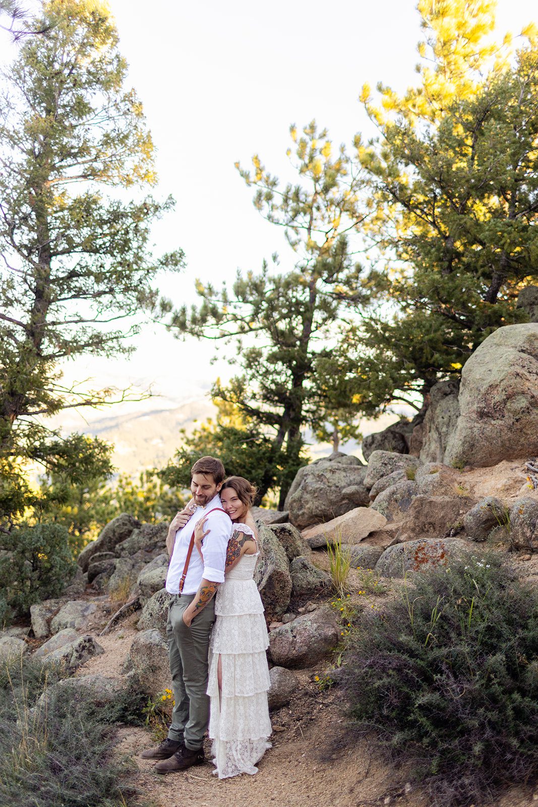 bride wrapping her arms around groom after sunrise elopement at artist point 