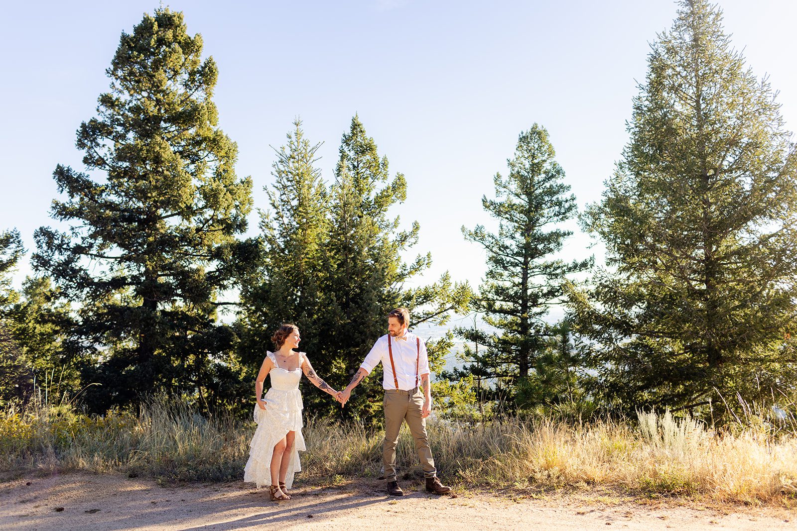 bride and groom walking hand in hand at sunrise after Artist point elopement