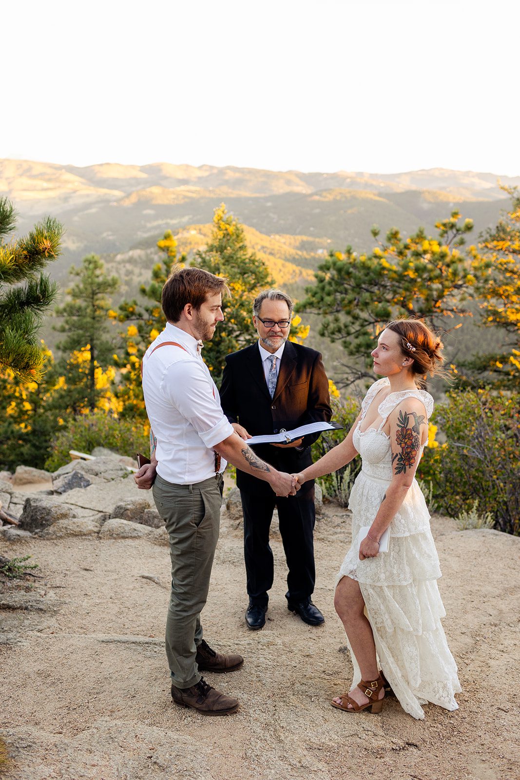 bride and groom holding hands at sunrise for their elopement ceremony at Artist Point