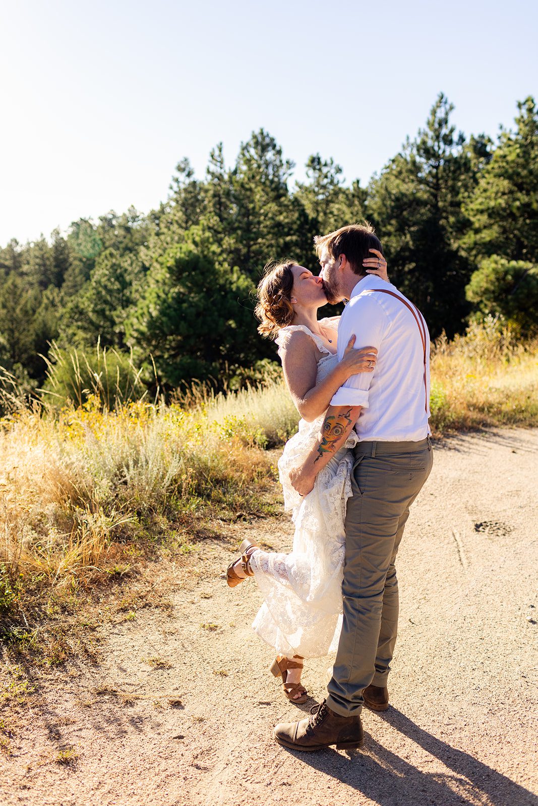 bride and groom bridal portrait, kissing after sunrise elopement in Colorado