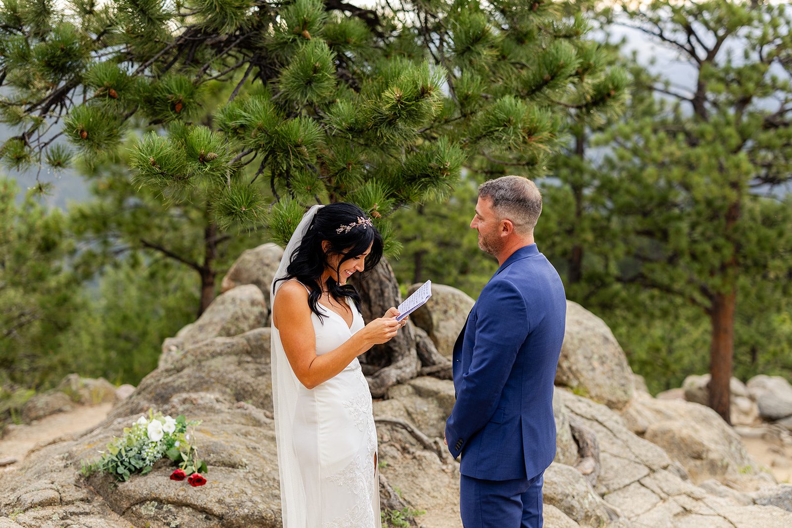bride laughing, smiling while reading vows during elopement ceremony