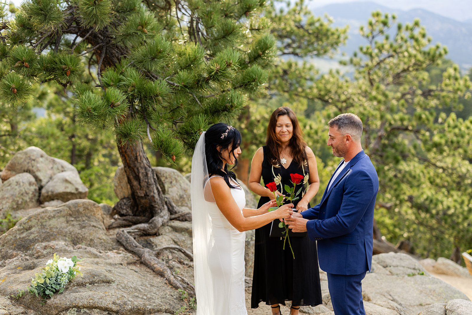 bride and groom exchange roses during rose ceremony at Artist Point.