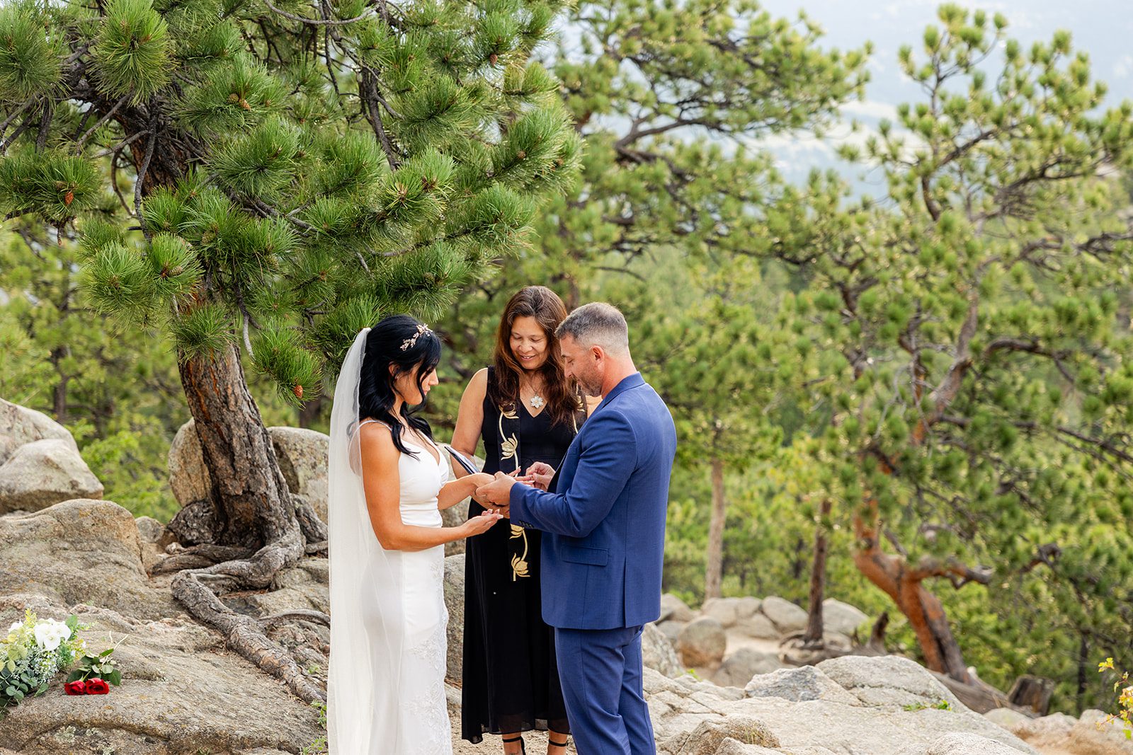 groom placing ring on his bride's hand during Artist Point elopement ceremony. 