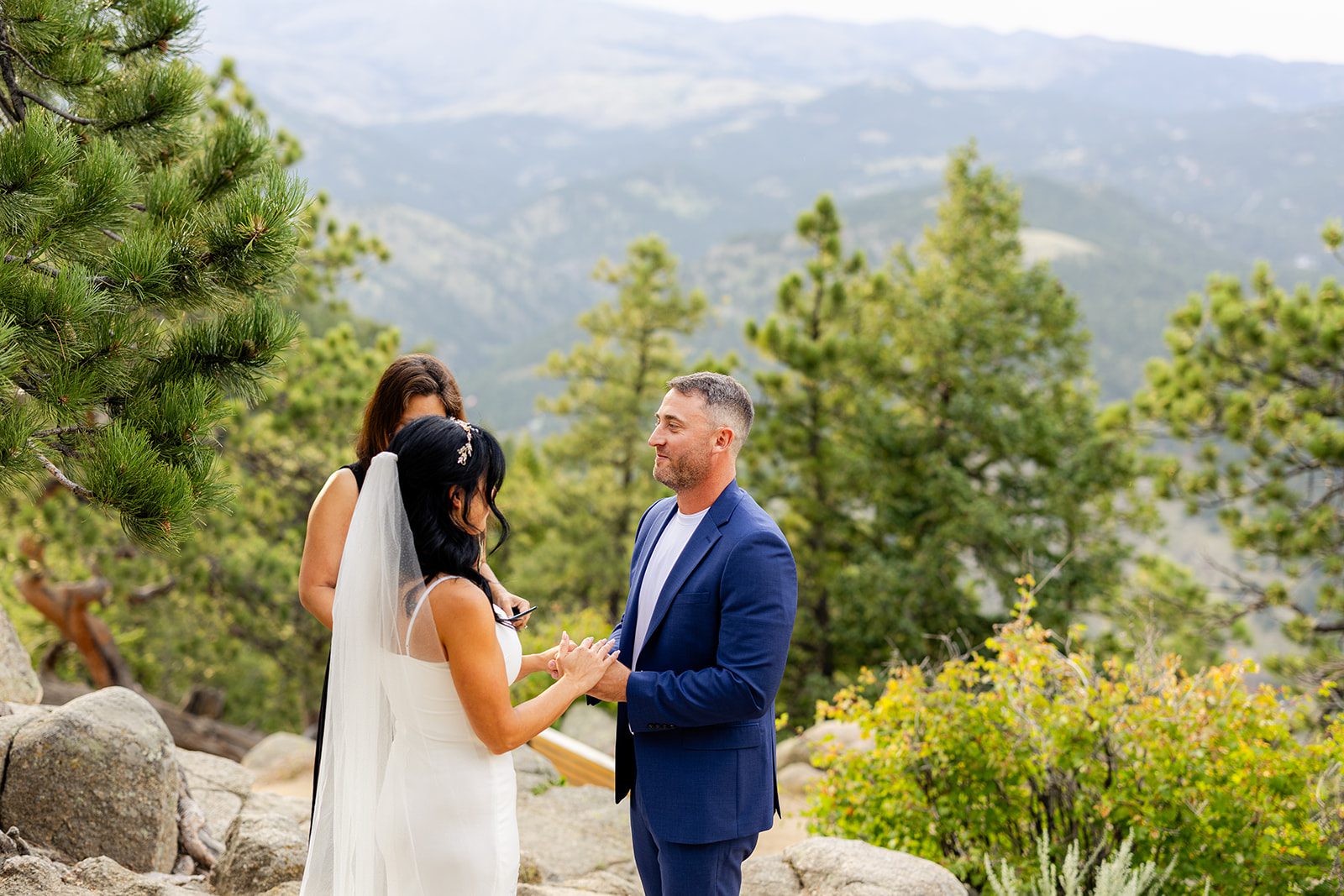 groom holding hands with bride during artist point elopement ceremony