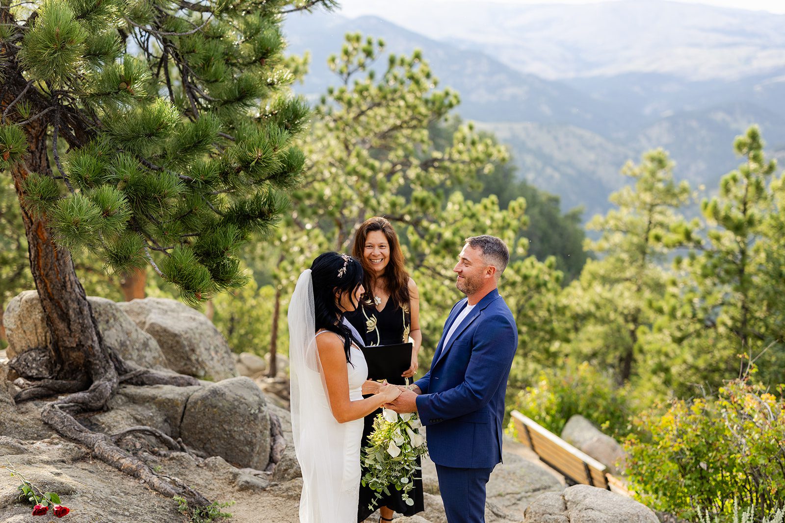 Bride and groom holding hands during Artist point elopement ceremony 