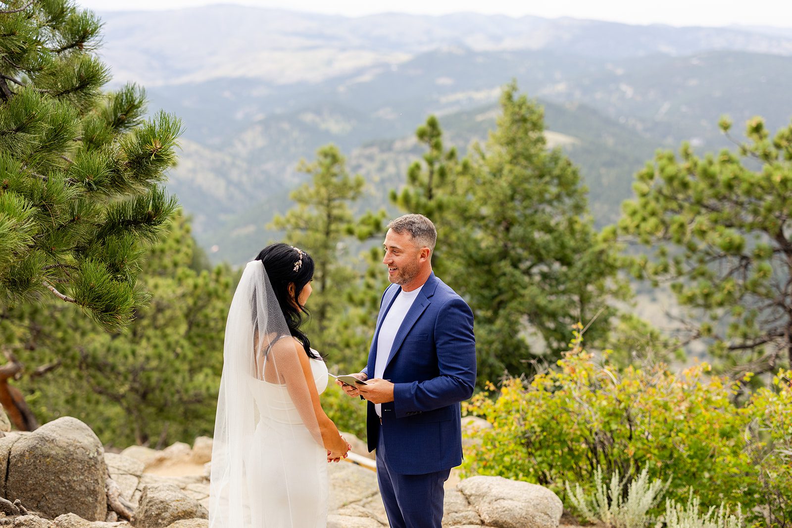 Groom reading vows to bride at elopement ceremony at Artist Point in Colorado. 