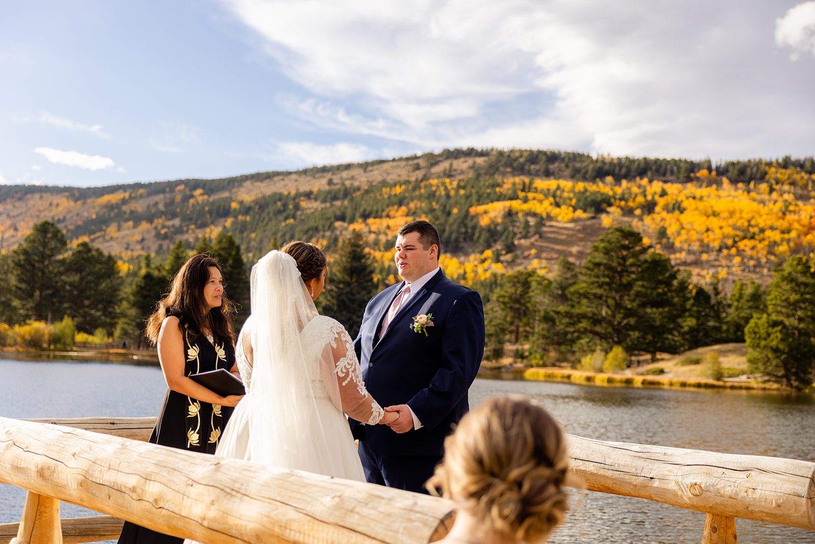 groom during Fall elopement ceremony at Sprague Lake. 