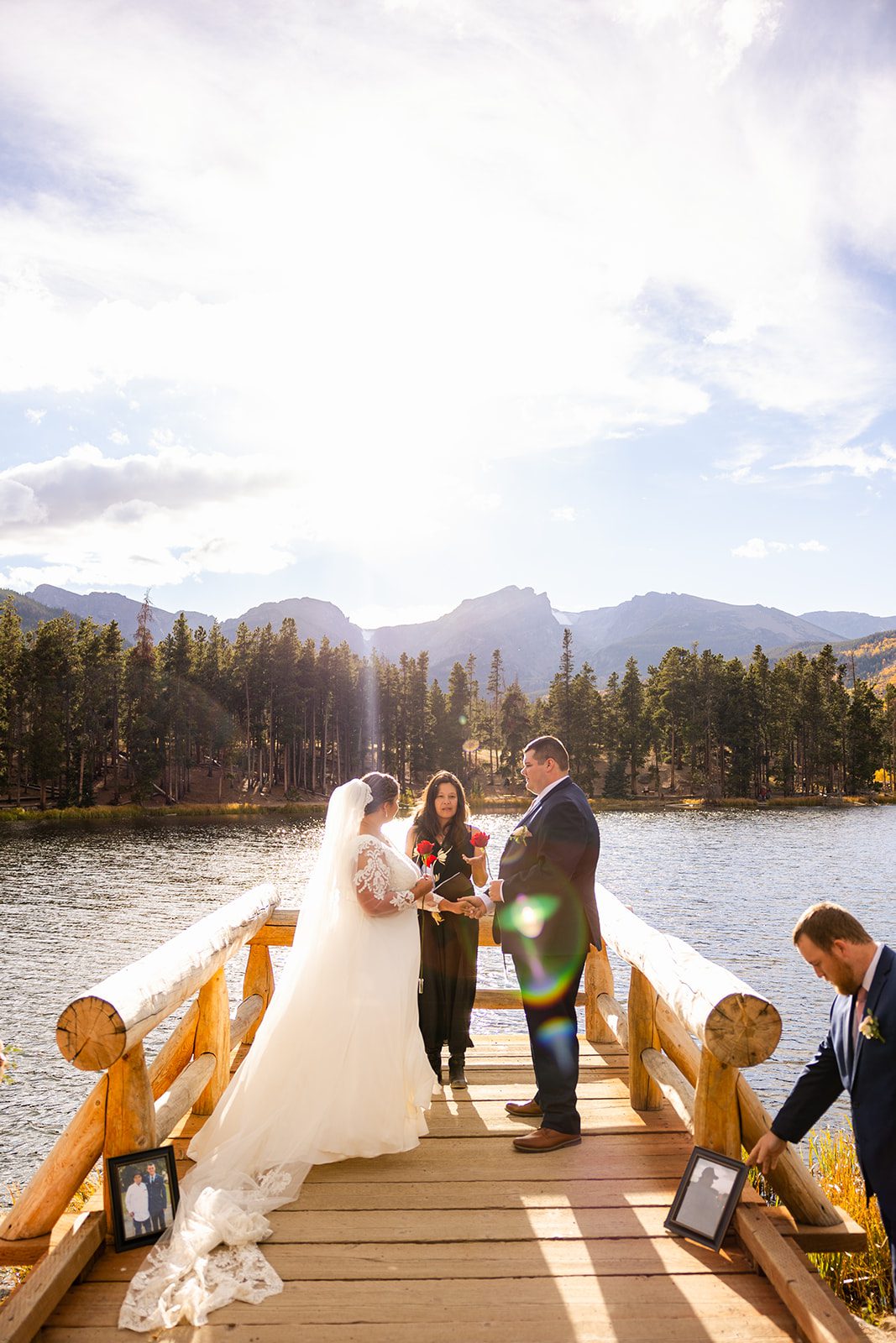 bride and groom during rose unity ceremony at their Fall elopement ceremony at Sprague Lake. 