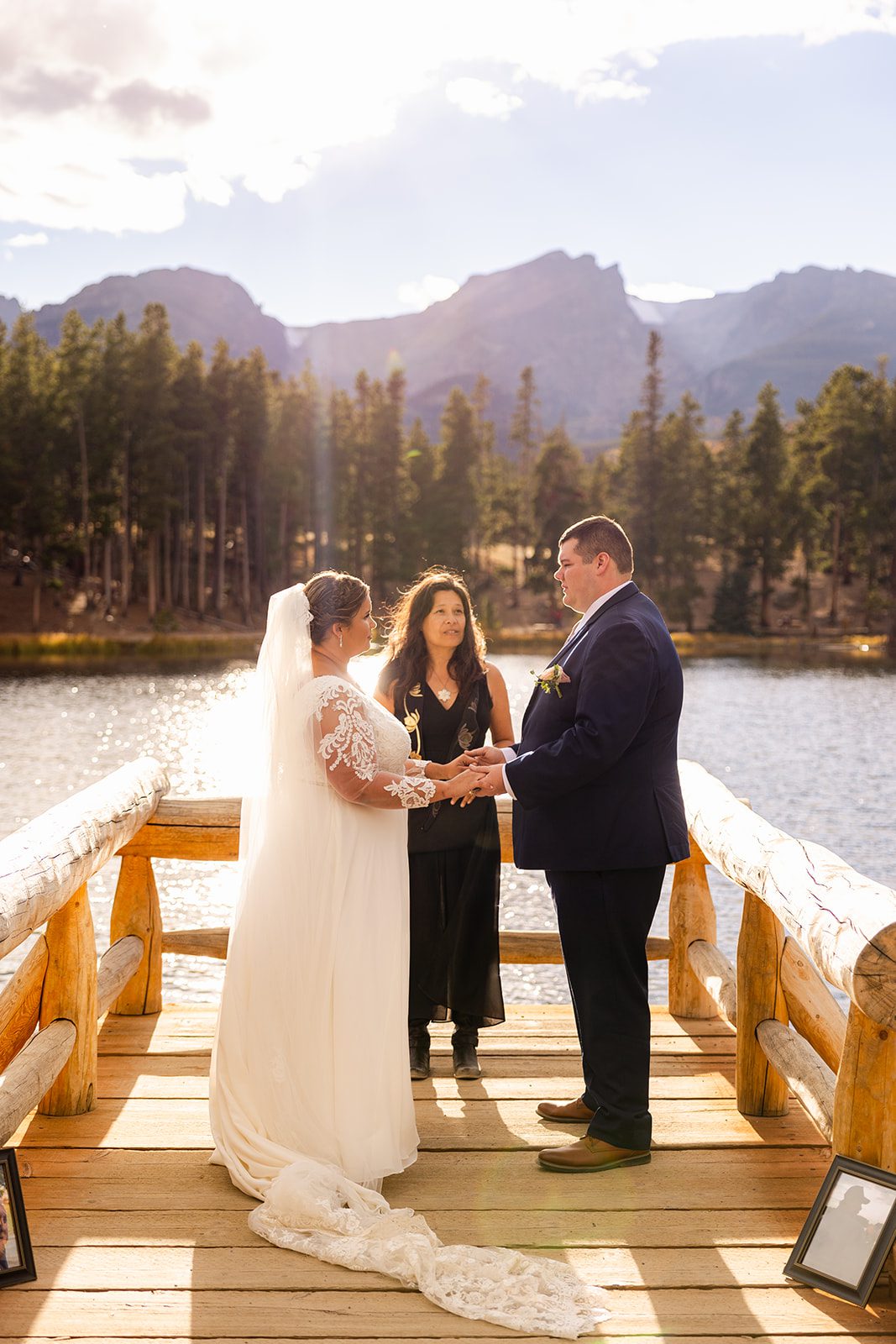 bride and groom hold hands during intimate Fall elopement ceremony at Sprague Lake
